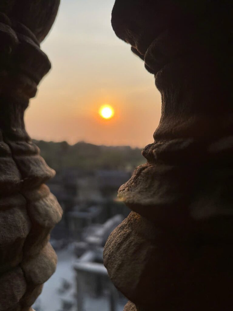Sunrise framed through ancient stone pillars at Angkor Wat, symbolizing hope, grounding, and inner safety.