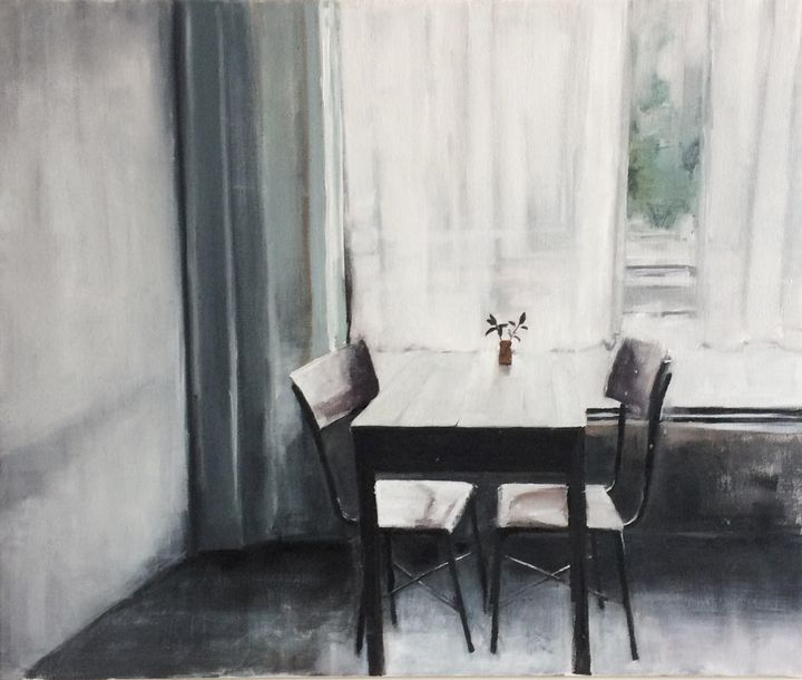 A quiet table with two chairs by a window in soft morning light, conveying stillness and reflection.